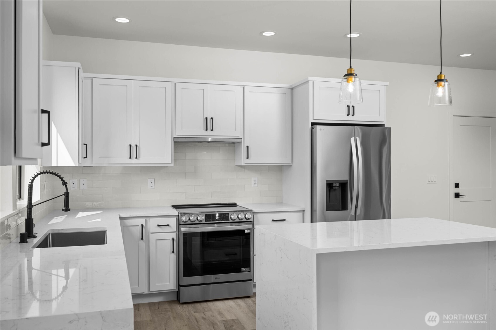 3906 Crosswinds Court Anacortes, WA 98221 - Photo 5 of 16 a kitchen with stainless steel appliances granite countertop a sink a stove and a refrigerator
