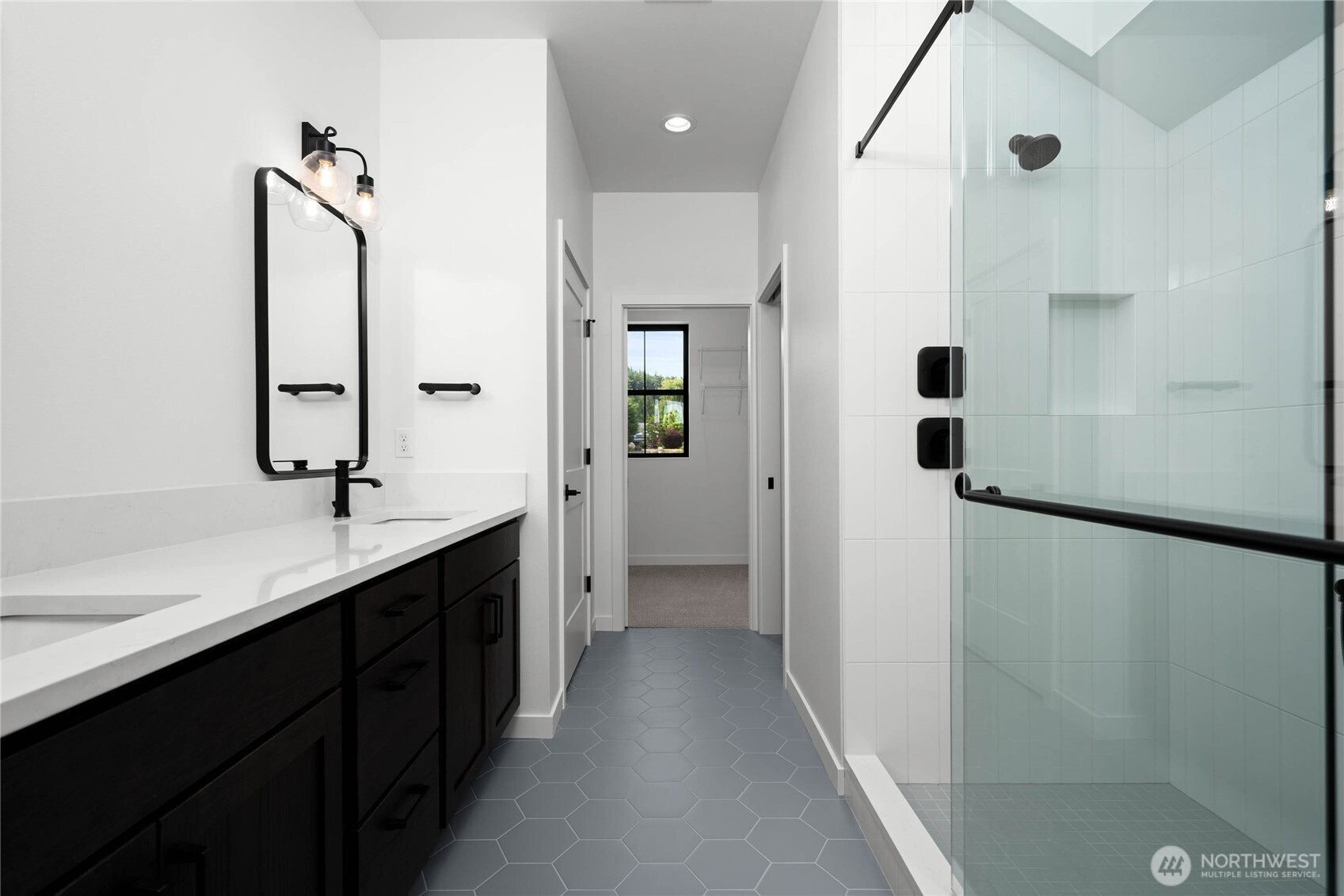 3906 Crosswinds Court Anacortes, WA 98221 - Photo 7 of 16 a bathroom with a double vanity sink a toilet and shower