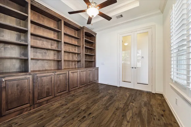 a view of an empty room with cabinet and a window