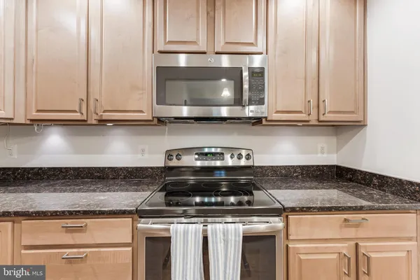 a stove top oven sitting inside of a kitchen