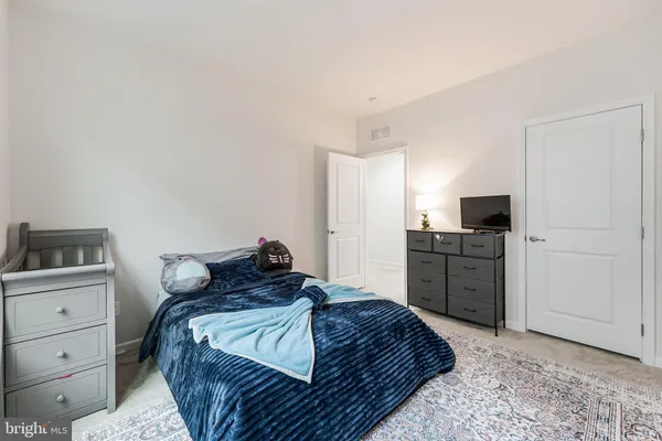 a bedroom with a bed and flat screen tv