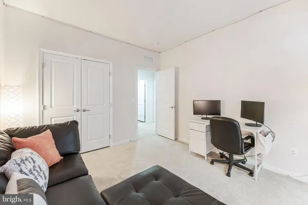 a view of a livingroom with workspace and a couch