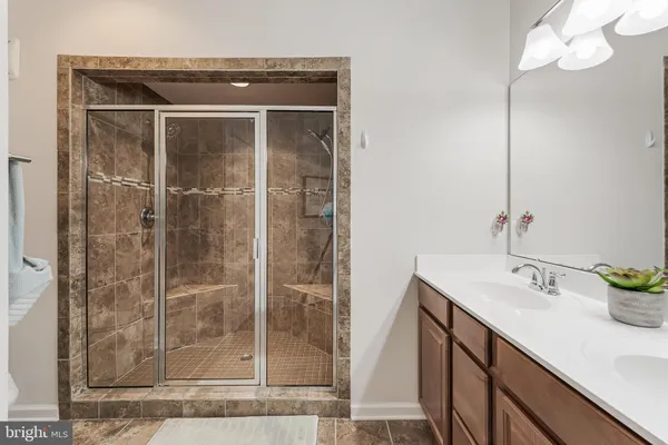 a bathroom with a shower sink and mirror