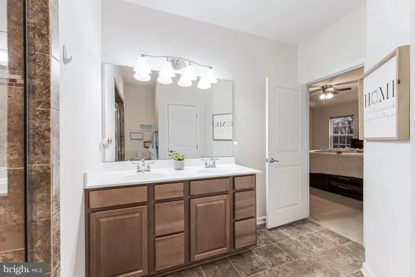 a en suite bathroom with double sink and a mirror