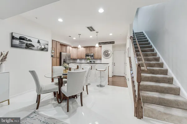 a view of kitchen with sink and chairs