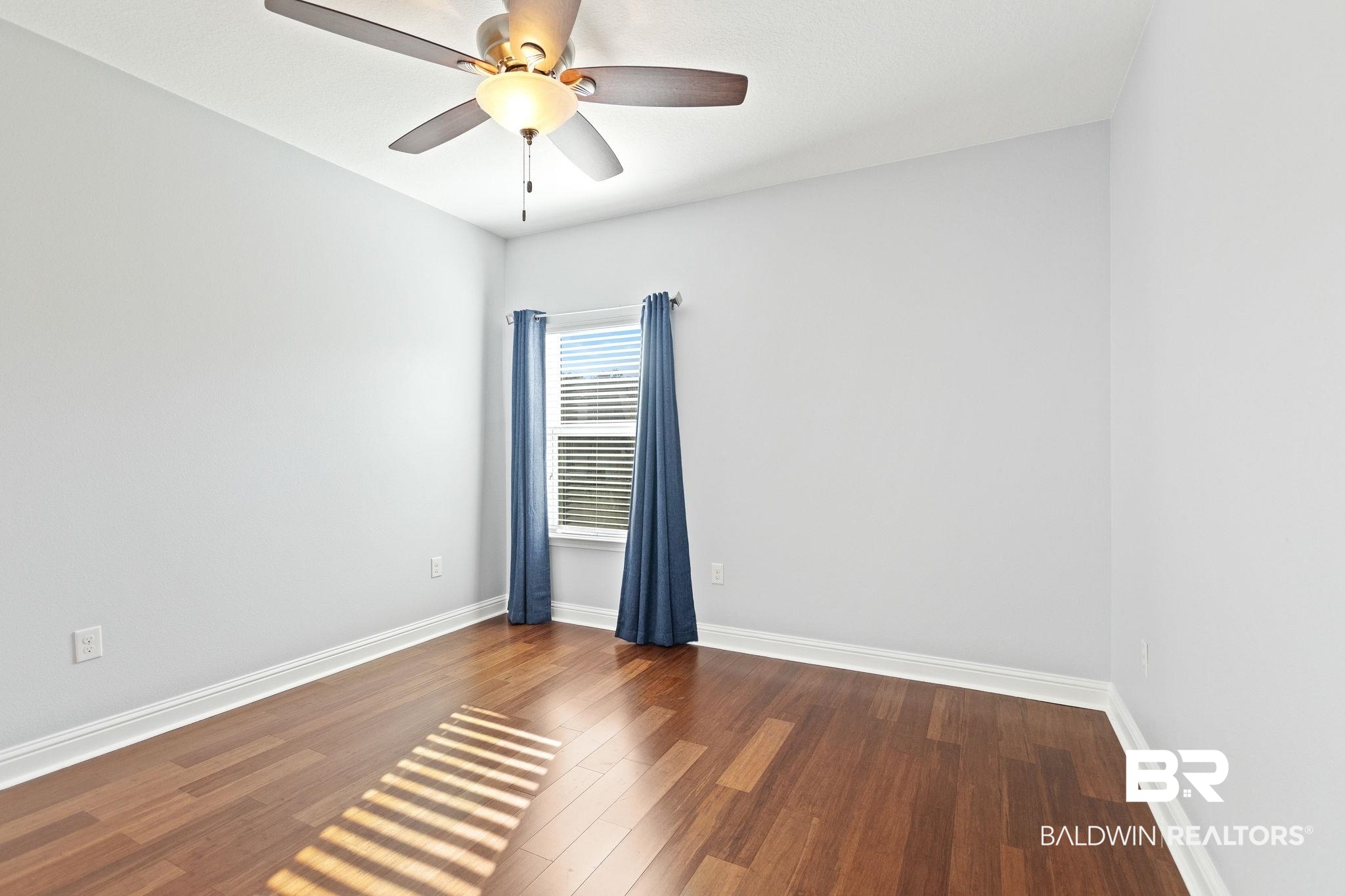 31541 Hoot Owl Road Daphne, AL 36527 - Photo 34 of 51 Unfurnished room with ceiling fan and wood-type flooring