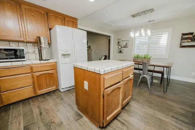 a kitchen with a stove a refrigerator and a dining table