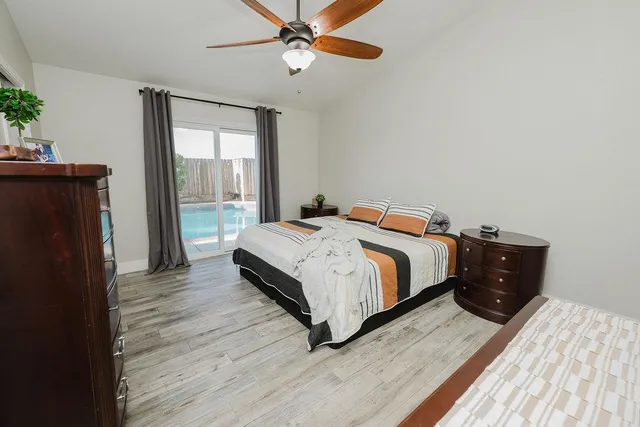 a bedroom with a bed and wooden floor