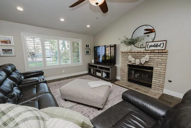 a living room with furniture flat screen tv and a fireplace