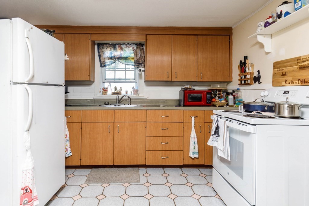 26 Lovell Road Holden, MA 01520 - Photo 12 of 26 a kitchen with a sink stove and cabinets