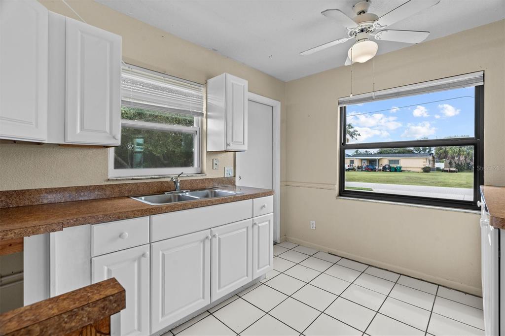 27242 Sunnybrook Road Punta Gorda, FL 33983 - Photo 12 of 36 a kitchen with stainless steel appliances granite countertop white cabinets and window