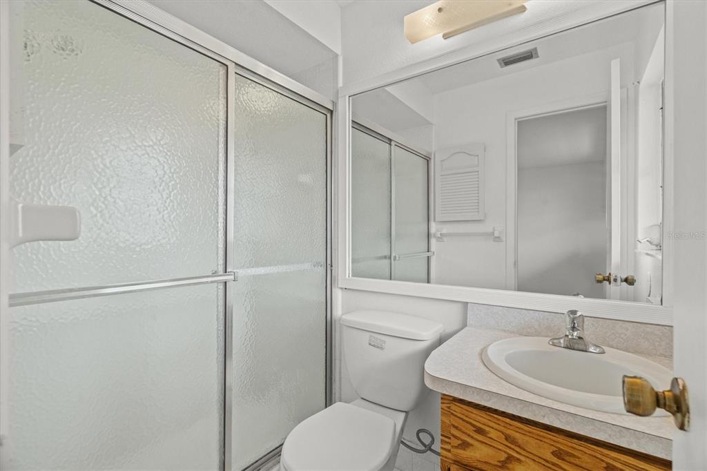 27242 Sunnybrook Road Punta Gorda, FL 33983 - Photo 29 of 36 a bathroom with a granite countertop sink toilet and shower