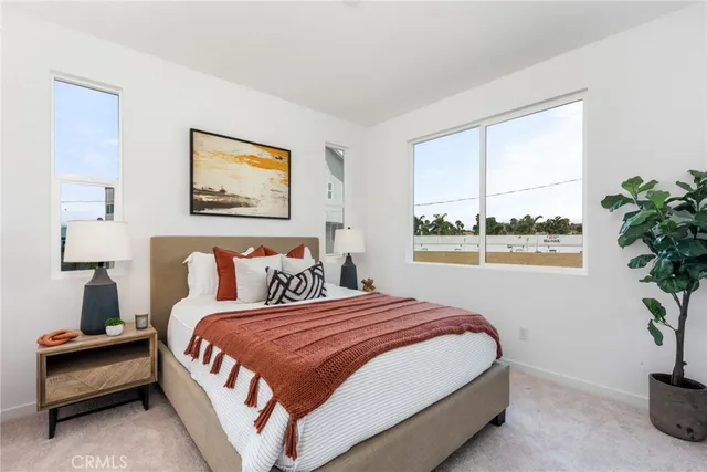 a bedroom with bed and a potted plant