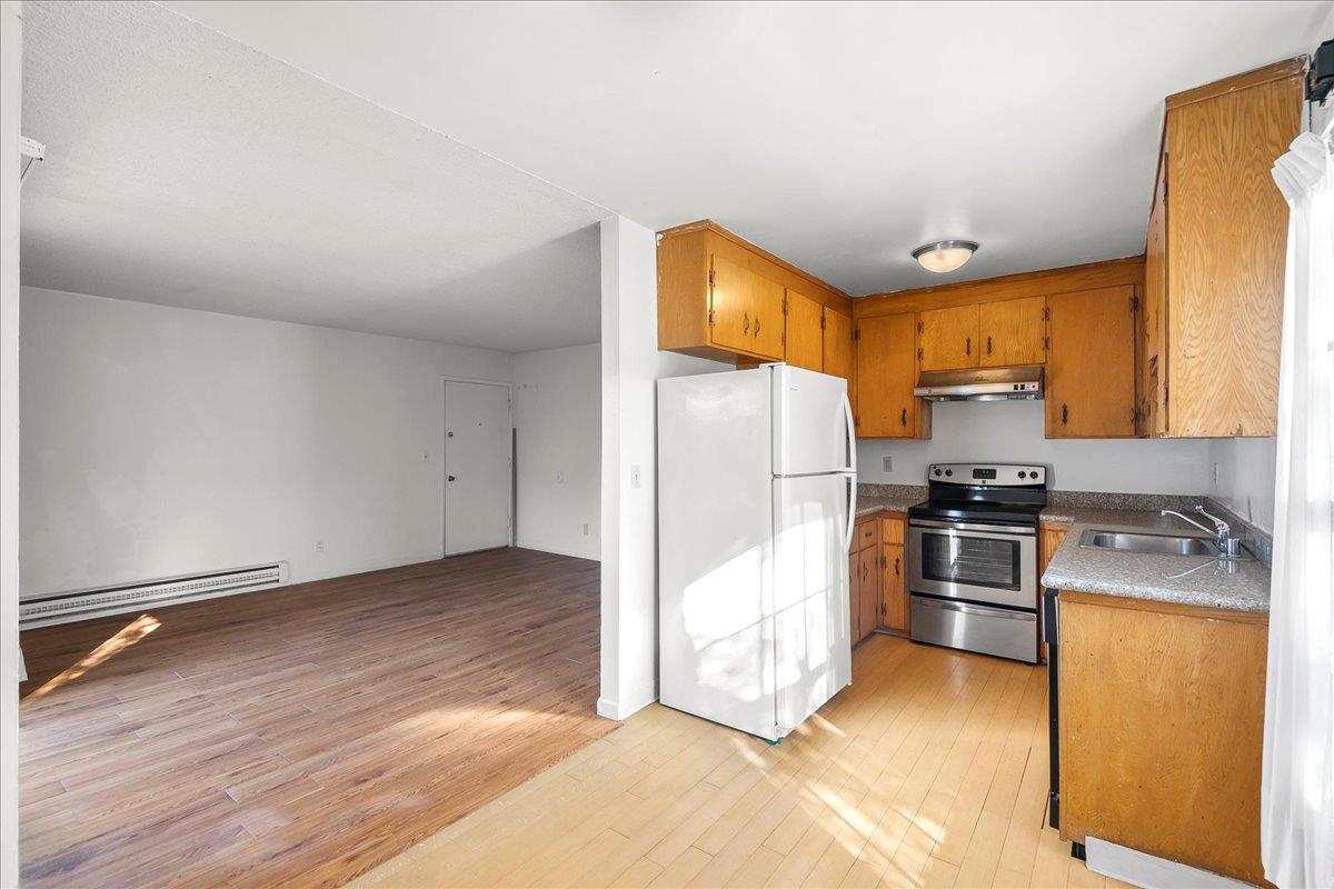 1285 Ayala Drive Sunnyvale, CA 94086 - Photo 14 of 23 a kitchen with granite countertop a refrigerator and a stove top oven