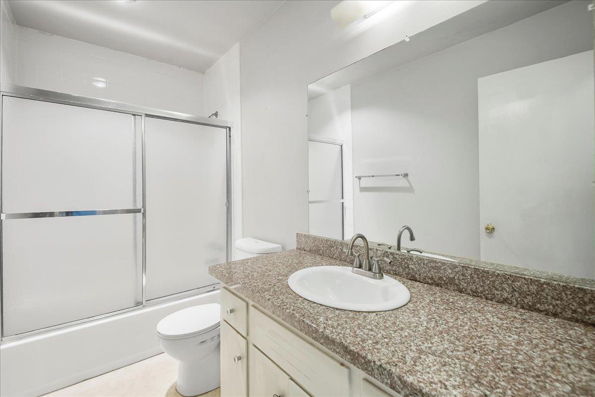 1285 Ayala Drive Sunnyvale, CA 94086 - Photo 15 of 23 a bathroom with a granite countertop sink toilet and shower
