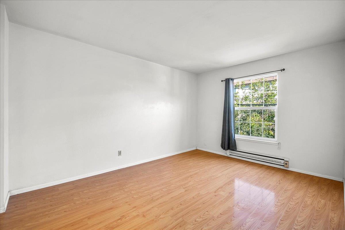 1285 Ayala Drive Sunnyvale, CA 94086 - Photo 17 of 23 an empty room with wooden floor and windows