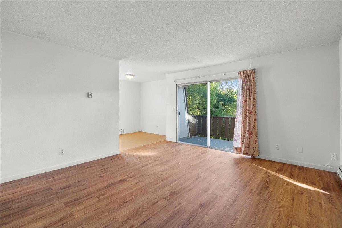 1285 Ayala Drive Sunnyvale, CA 94086 - Photo 20 of 23 a view of an empty room with wooden floor and a window