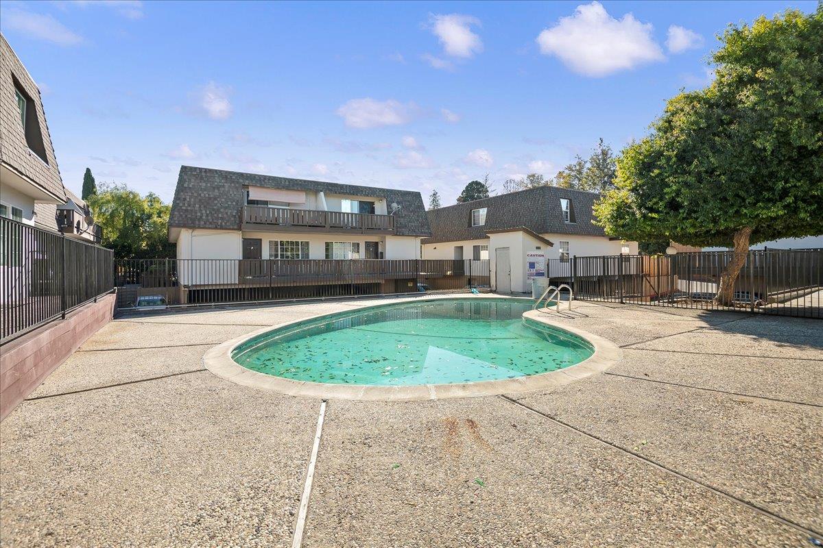 1285 Ayala Drive Sunnyvale, CA 94086 - Photo 4 of 23 a view of a white house with a swimming pool and a yard