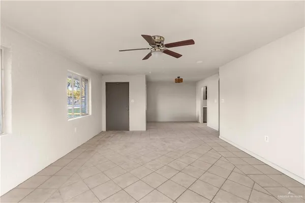 a view of a livingroom with a ceiling fan and window