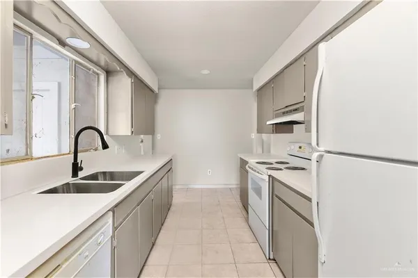 a kitchen with a sink and a refrigerator