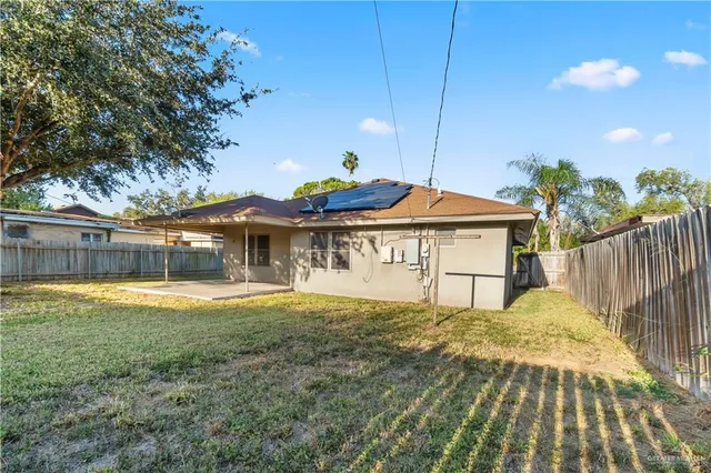 a view of house with backyard and deck