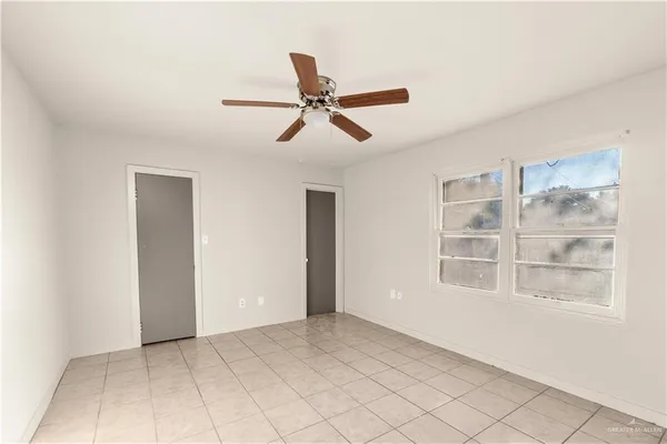 a view of a livingroom with a ceiling fan and window