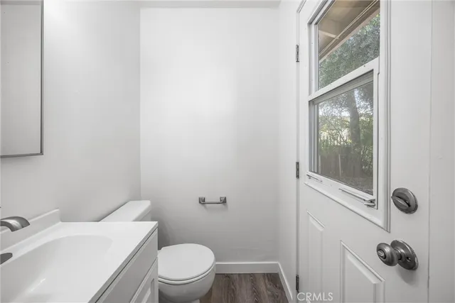 a bathroom with a toilet a sink and a mirror