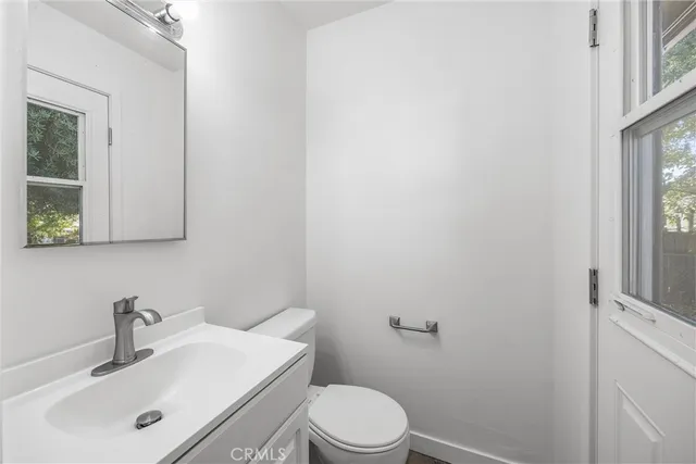 a bathroom with a sink a toilet and mirror