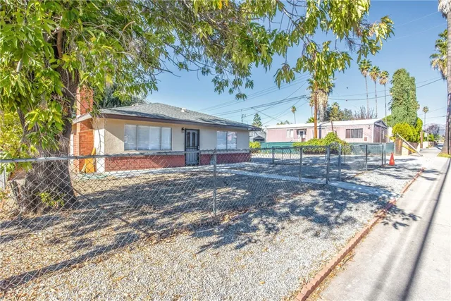 a view of a backyard with large trees