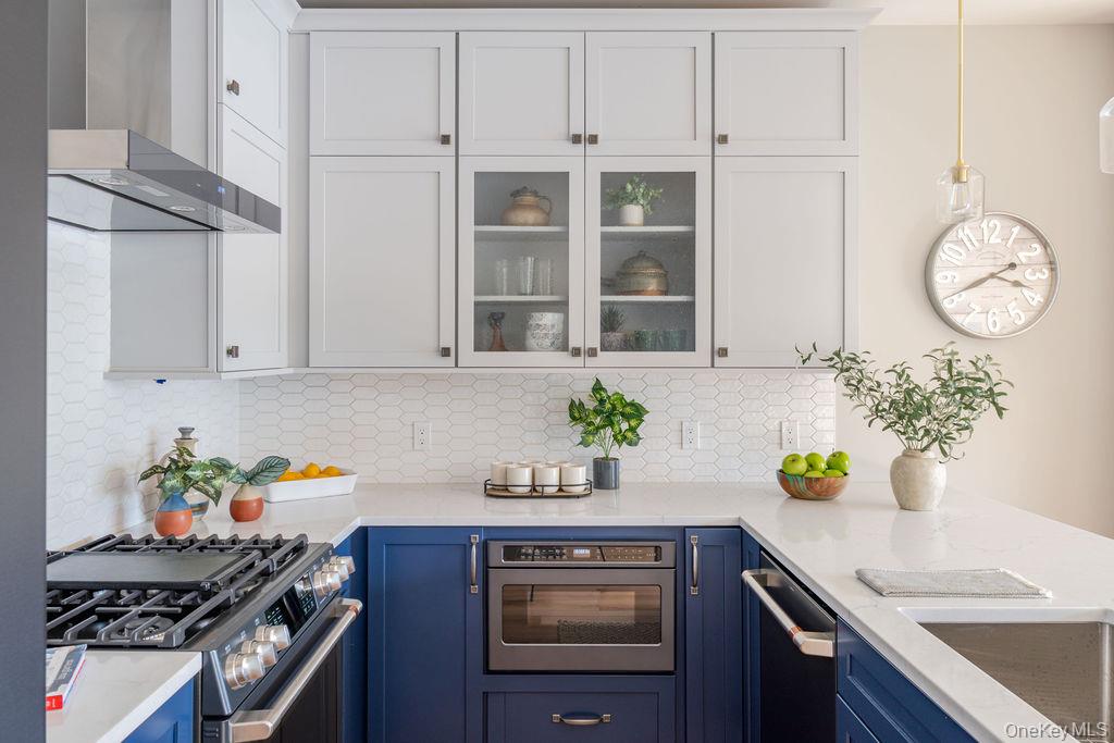 4 Icehouse Drive Saugerties, NY 12477 - Photo 13 of 34 Kitchen featuring blue cabinets, white cabinetry, wall chimney exhaust hood, and stainless steel appliances