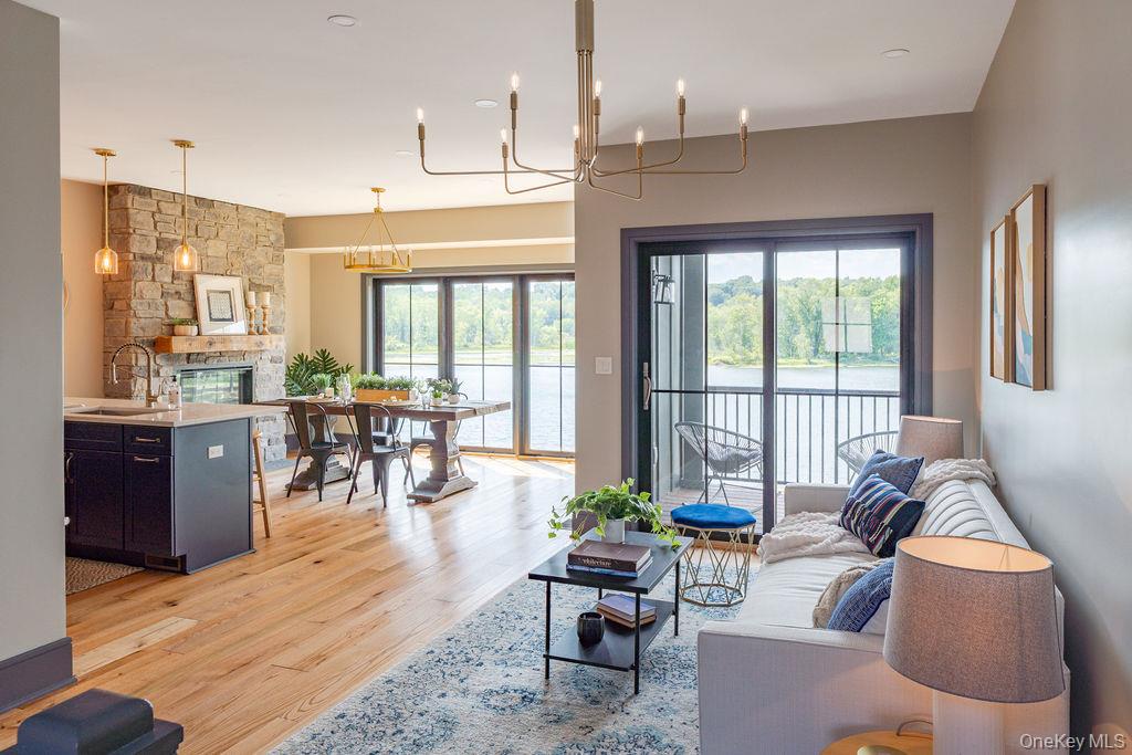 4 Icehouse Drive Saugerties, NY 12477 - Photo 3 of 34 Living area featuring light wood-style flooring, a fireplace, and a chandelier