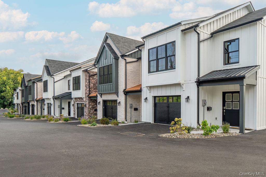 4 Icehouse Drive Saugerties, NY 12477 - Photo 31 of 34 Modern farmhouse style home featuring a residential view, board and batten siding, a garage, and asphalt driveway