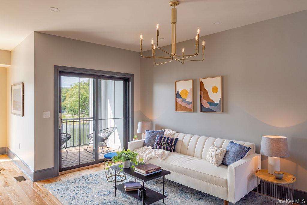 4 Icehouse Drive Saugerties, NY 12477 - Photo 6 of 34 Living area with wood finished floors and a chandelier