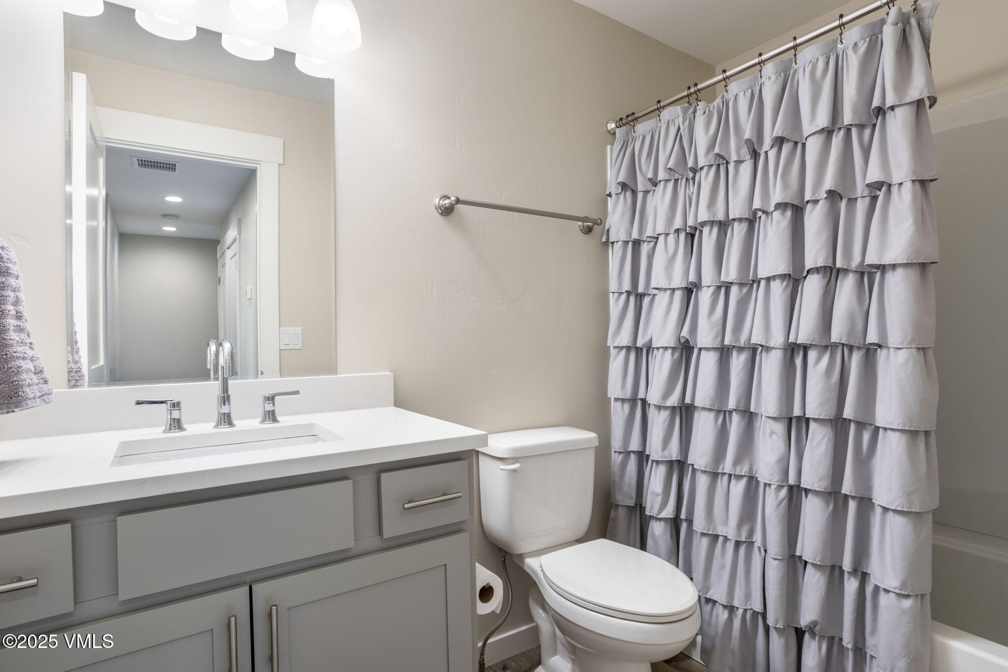 406 Chickadee Lane Gypsum, CO 81637 - Photo 21 of 24 a bathroom with a sink a toilet and shower curtain