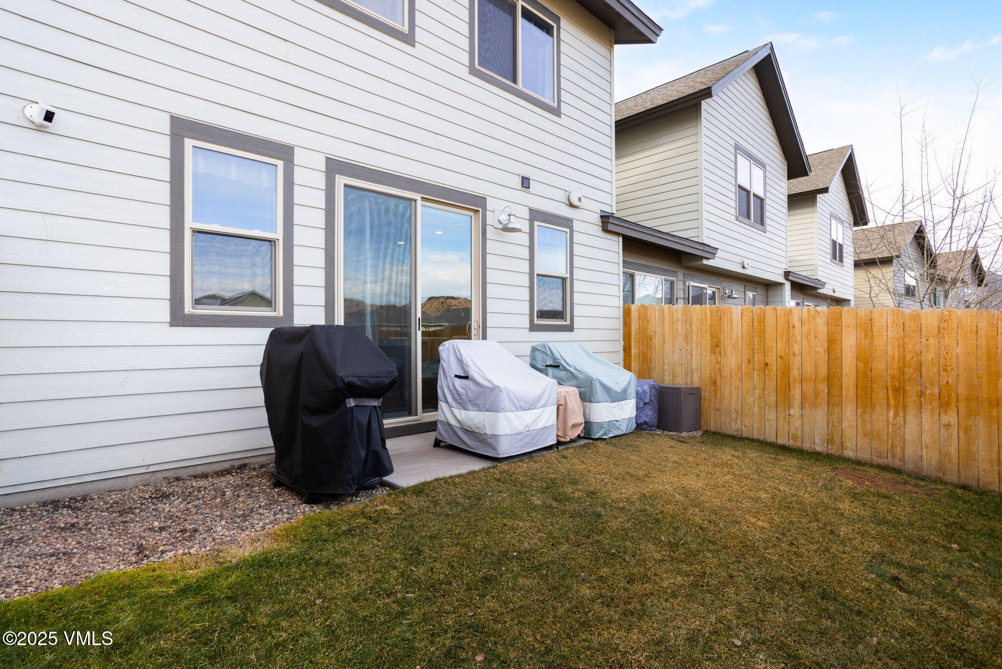 406 Chickadee Lane Gypsum, CO 81637 - Photo 23 of 24 a view of a patio with table and chairs and wooden fence
