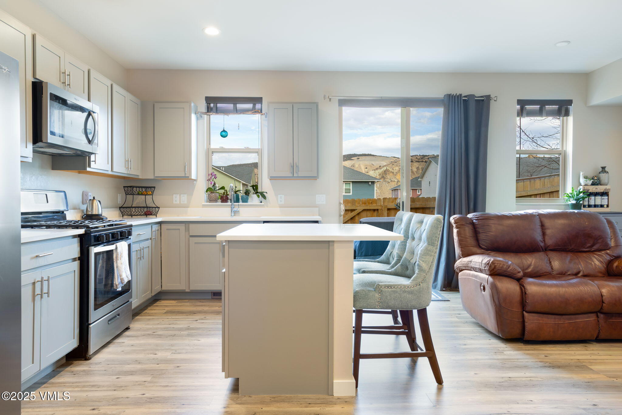 406 Chickadee Lane Gypsum, CO 81637 - Photo 9 of 24 a living room with stainless steel appliances granite countertop furniture wooden floor and a window