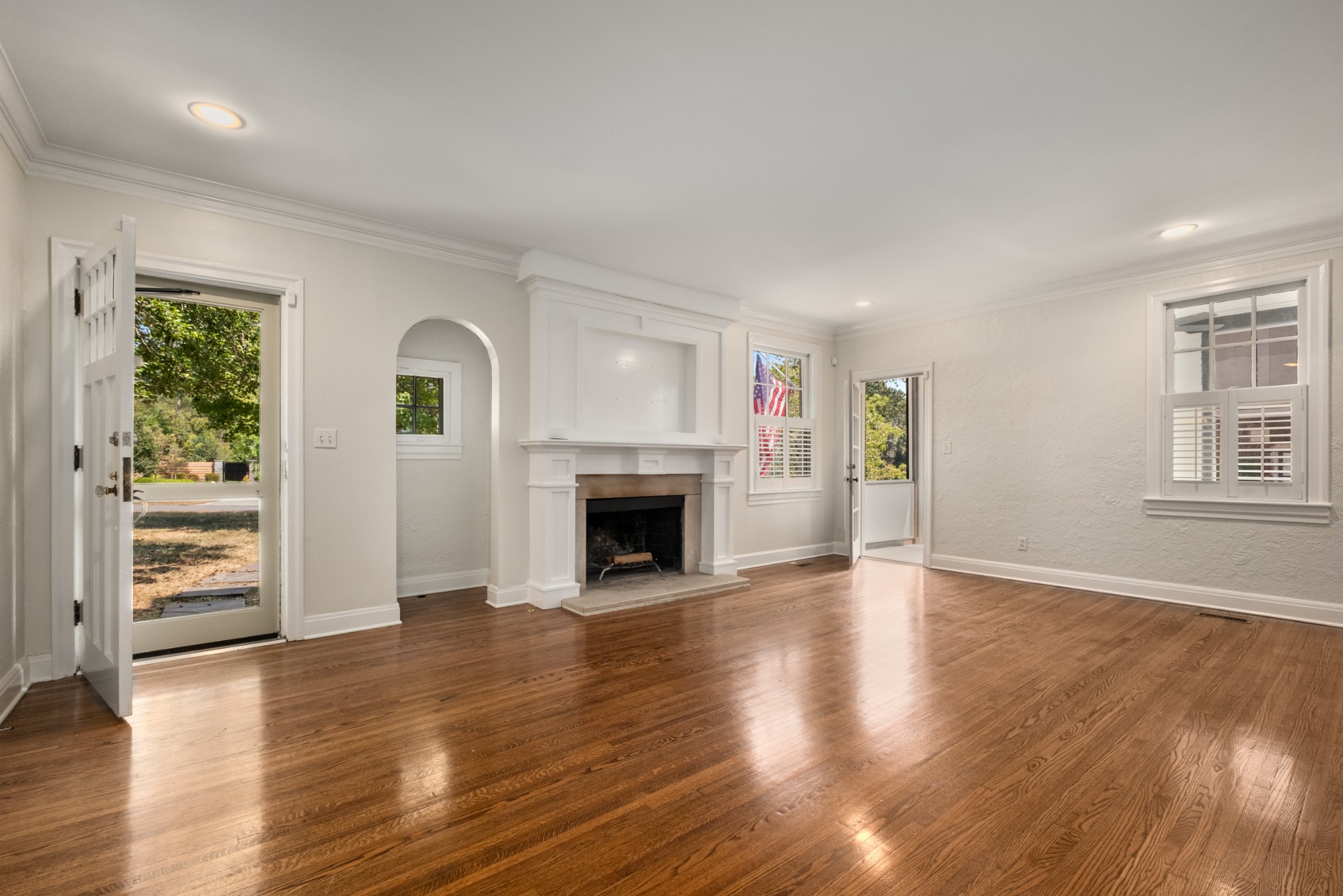 205 Mockingbird Road Nashville, TN 37205 - Photo 2 of 18 an empty room with wooden floor fireplace and windows