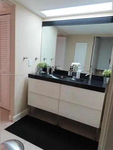 a white toilet sitting next to a shower