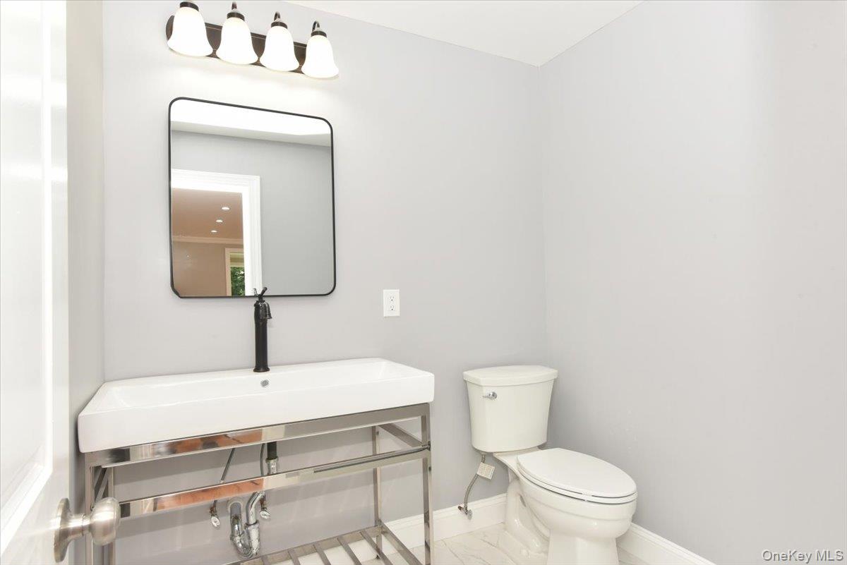 87 Dunlop Road Huntington, NY 11743 - Photo 11 of 31 a bathroom with a toilet sink and mirror