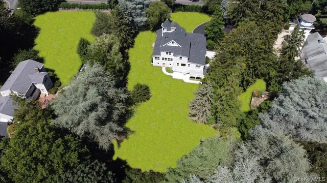 an aerial view of a house with a yard swimming pool outdoor seating and yard