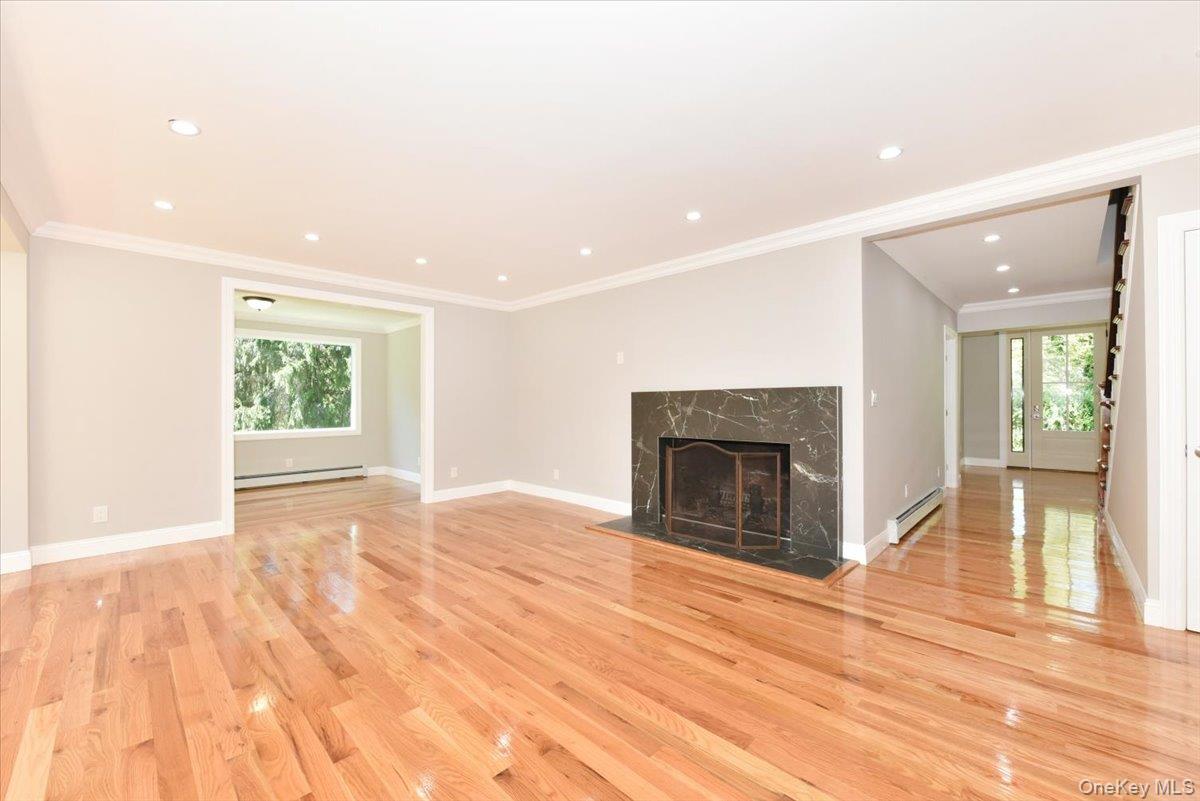 87 Dunlop Road Huntington, NY 11743 - Photo 3 of 31 a view of empty room with wooden floor and fireplace
