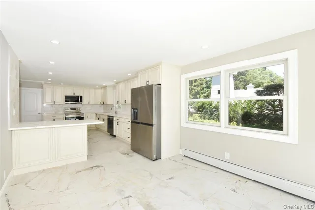 a kitchen with refrigerator and cabinets
