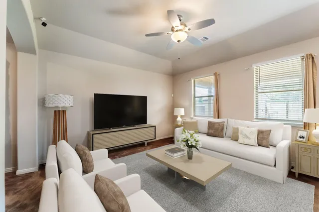 a living room with furniture and a flat screen tv