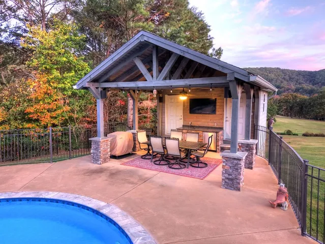 a front view of house with outdoor seating and yard