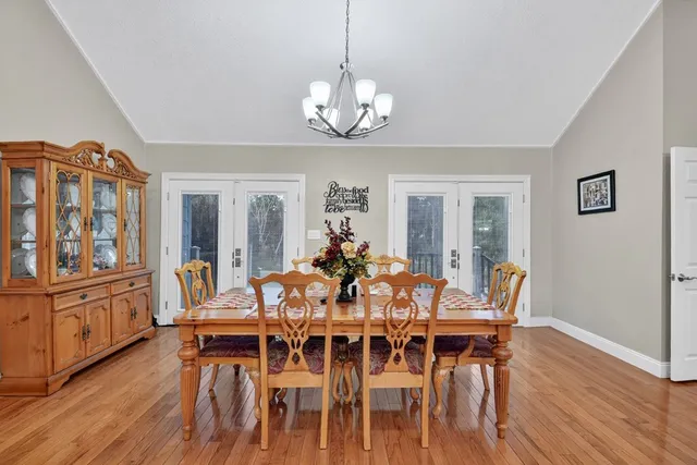 a view of a dining room with furniture wooden floor and chandelier