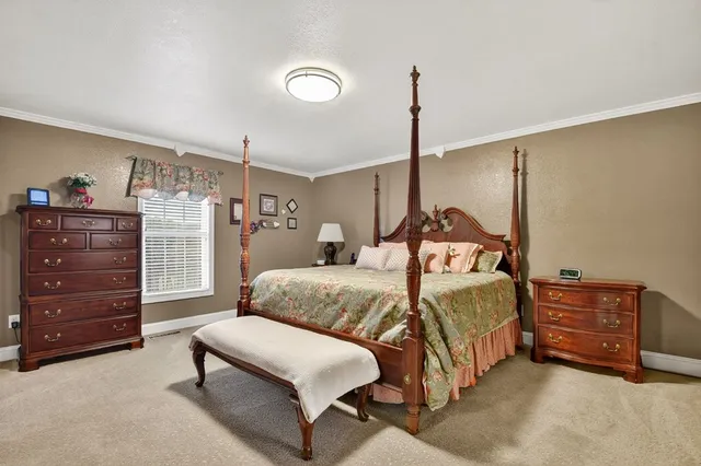 a bedroom with a bed and with furniture