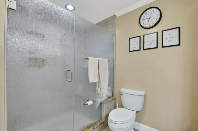 a bathroom with a toilet and a shower