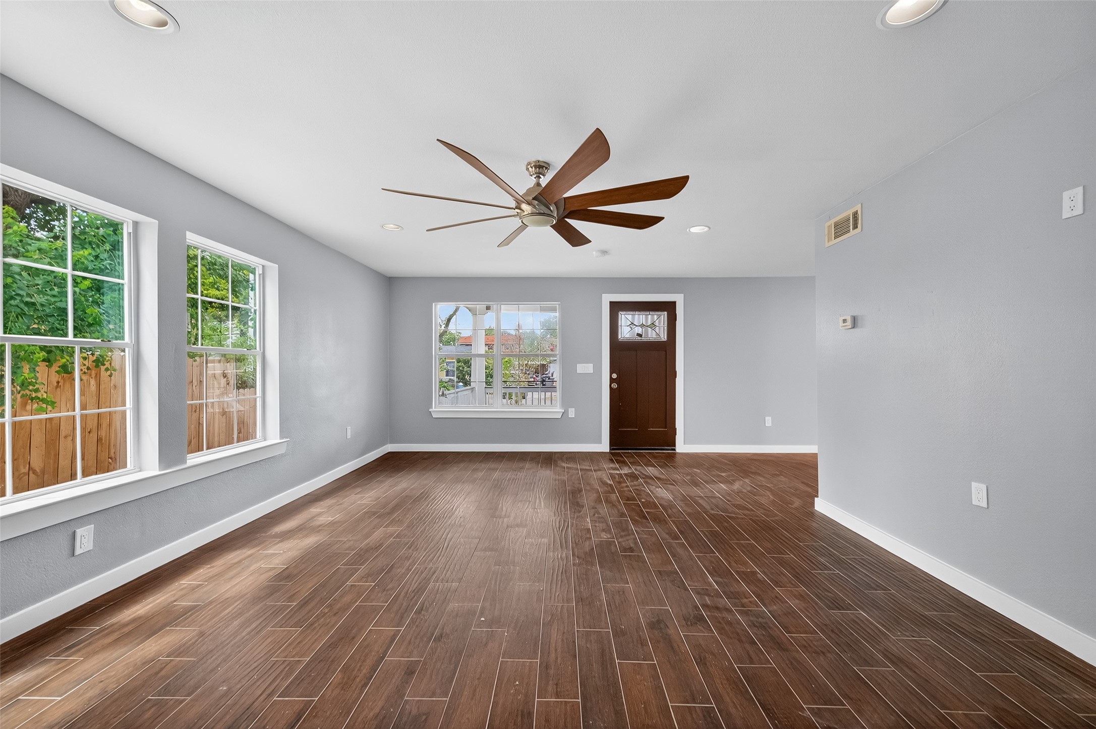 1933 Santa Rosa Street Houston, TX 77023 - Photo 12 of 44 a view of empty room with wooden floor and fan