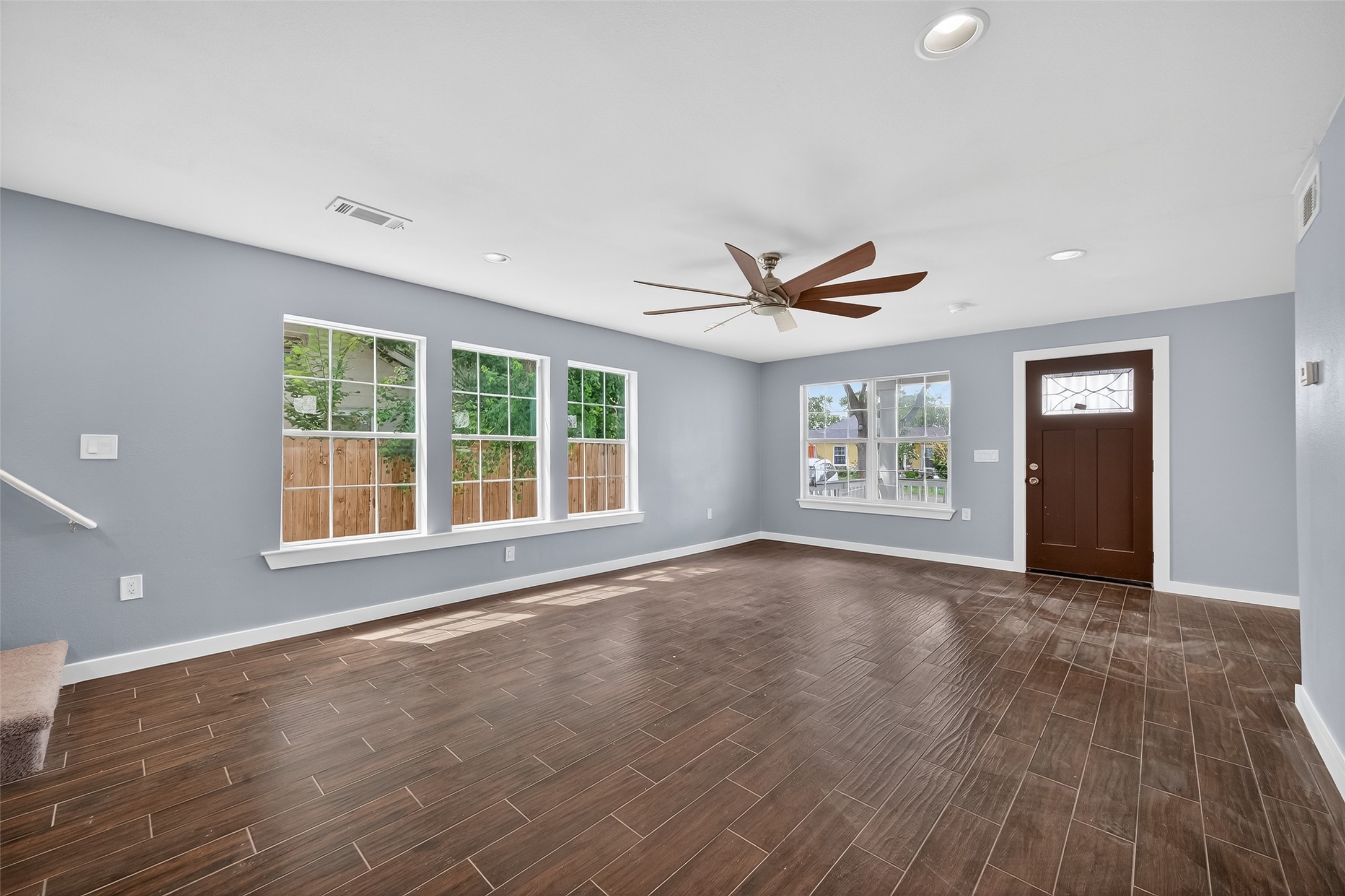 1933 Santa Rosa Street Houston, TX 77023 - Photo 13 of 44 a view of an empty room with a window and wooden floor