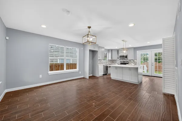 a view of a kitchen with stove and cabinets